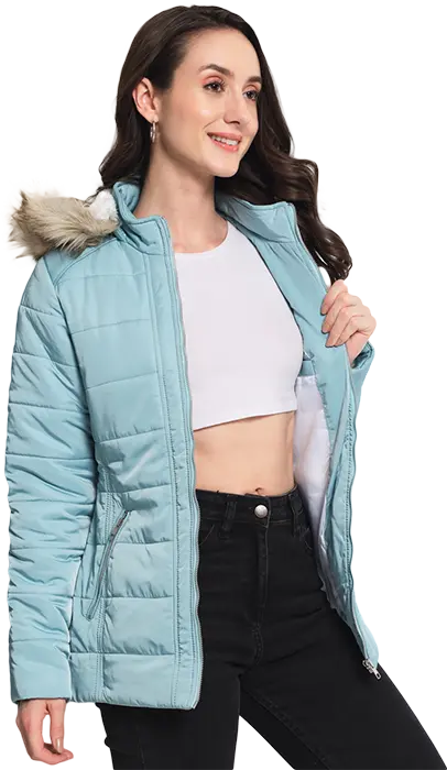 A full image of a woman wearing a sky blue full sleeve jacket with hood and faux fur food and side pockets.