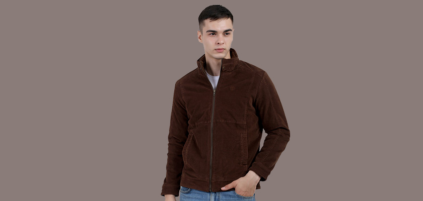 A man wearing a Brown Corduroy jacket with a collar neck, zipper closure and pocket in hand designed for casual winter layering and comfort