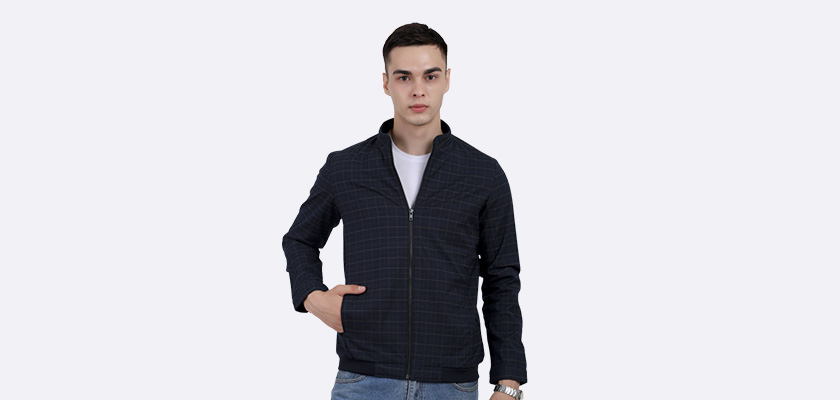 A man wearing a navy cotton washed winter jacket with fleece lining,mock collar, zipper closure, and pocket in hand designed for casual winter layering and comfort