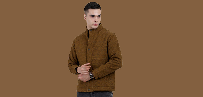 A man wearing a mustard High Neck Quilted Jacket with zipper closure Button Placket, and pocket in hand designed for casual winter layering and comfort