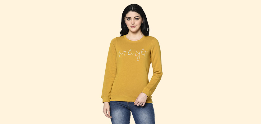 A woman wearing a Mustard Sweatshirt with round neck and ribbed cuff designed for mild winter