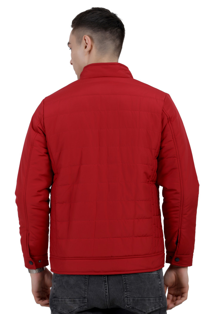 A back pose of a Mustard wearing a Red quilted jacket with a high neck collar, zipper closure and pocket in hand designed for casual winter layering and comfort.