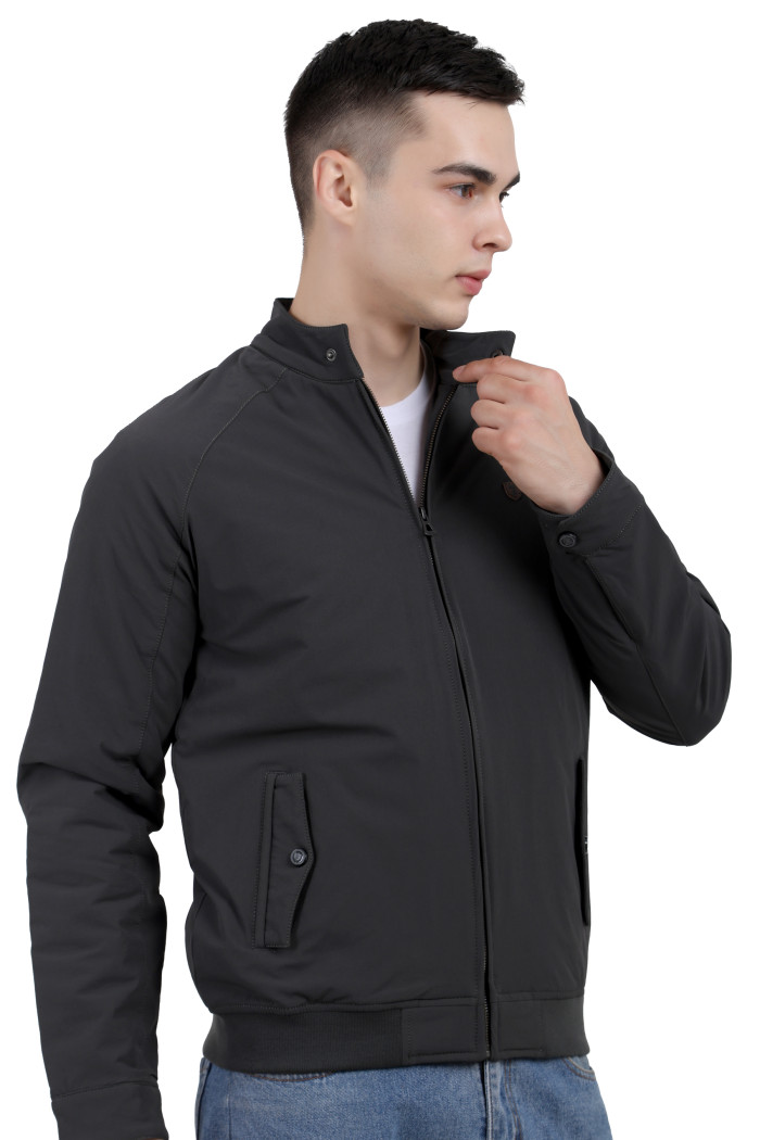 A right pose of a man wearing an olive quilted jacket with a high neck collar, zipper closure and pocket in hand designed for casual winter layering and comfort.