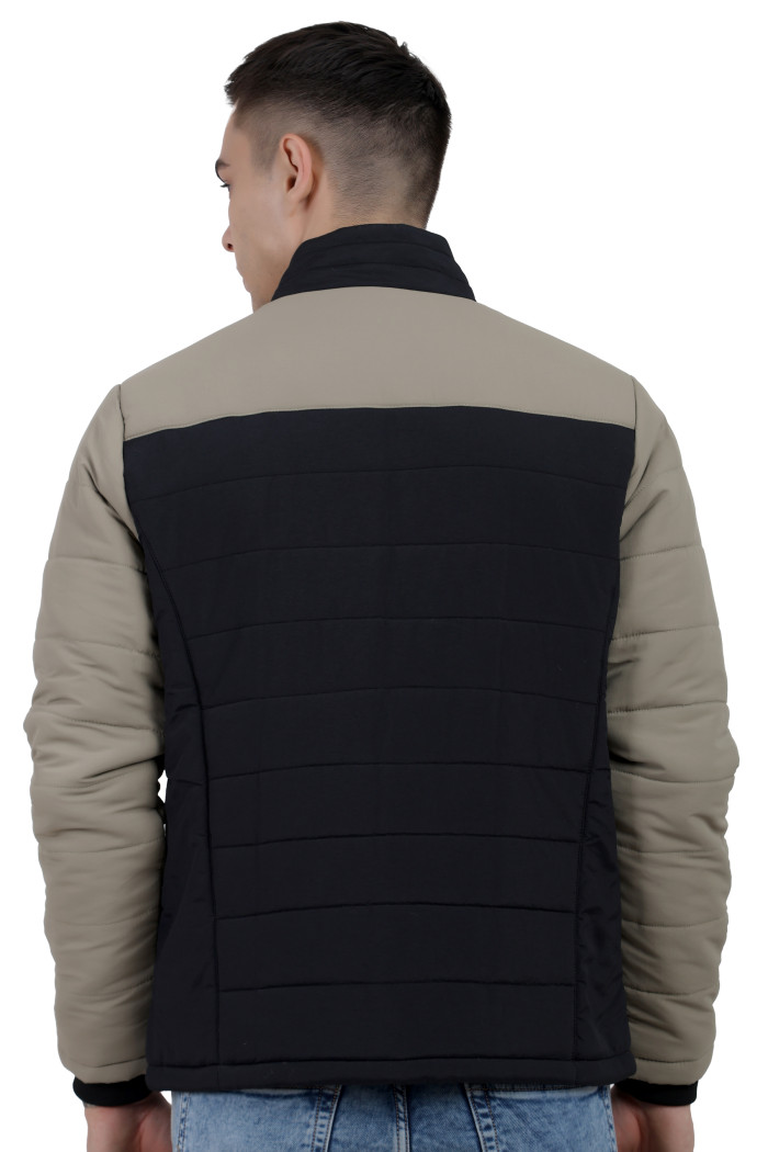 A back pose of a man wearing a Black-Camel dual Tone Quilted Jacket with mock collar, zipper closure and pocket in hand designed for casual winter layering and comfort.