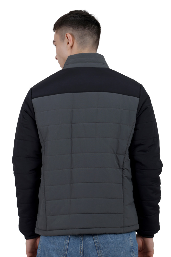 A back pose of a man wearing a Black-Grey dual Tone Quilted Jacket with mock collar, zipper closure and pocket in hand designed for casual winter layering and comfort.