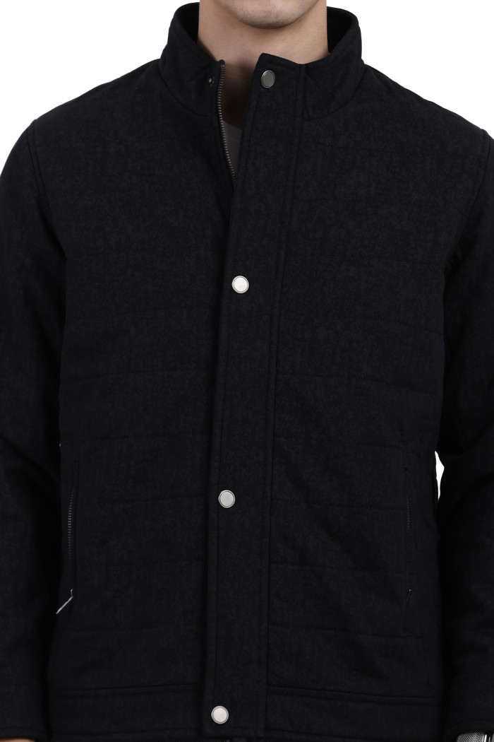 A cropped image of a man wearing a Black High Neck Quilted Jacket with zipper closure Button Placket, and pocket in hand designed for casual winter layering and comfort.