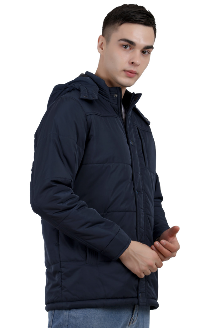 A right pose of a Navy wearing aRed quilted jacket with a high neck collar, hood , zipper closure and pocket in hand designed for casual winter layering and comfort.