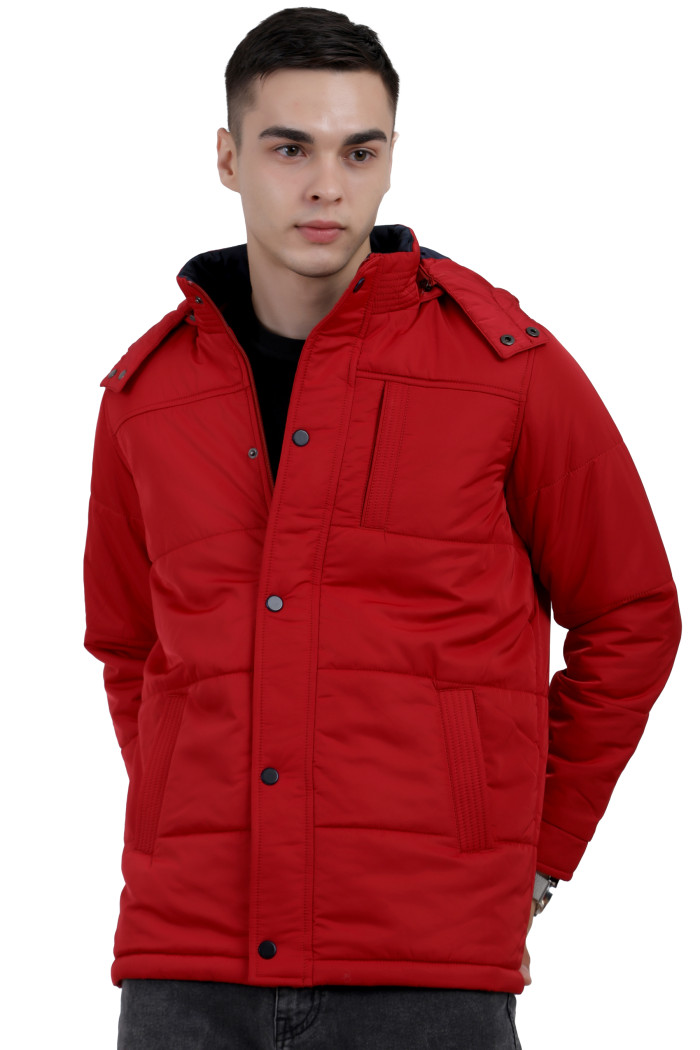 A man wearing a Red quilted jacket with a high neck collar, hood , zipper closure and pocket in hand designed for casual winter layering and comfort.