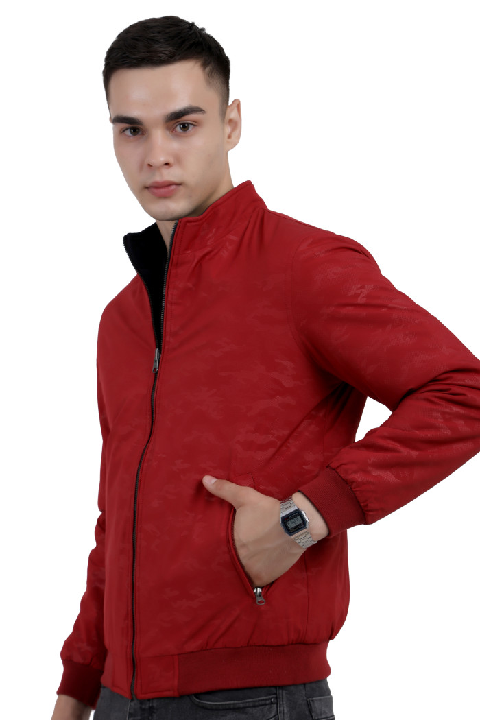 A left pose of a man wearing a Red- Navy Reversible jacket with a high neck collar, zipper closure and pocket in hand designed for casual winter layering and comfort.