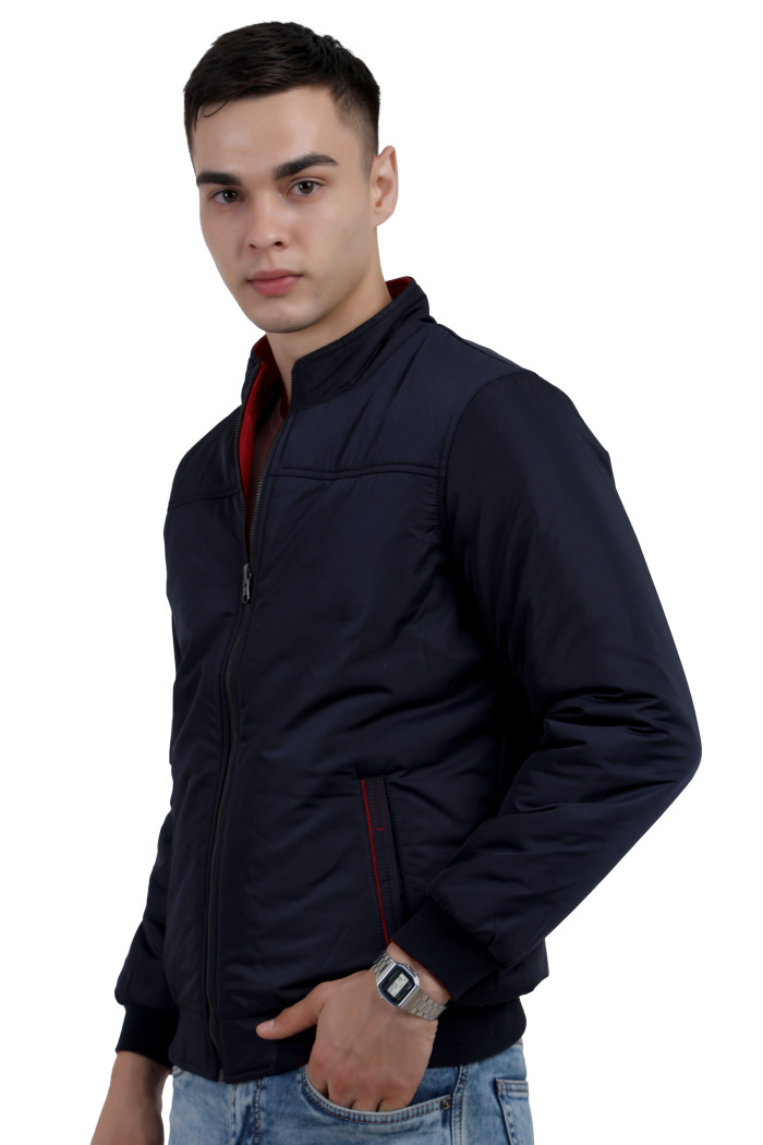 A left pose of a man wearing a Navy-Red Reversible jacket with a high neck collar, zipper closure and pocket in hand designed for casual winter layering and comfort.