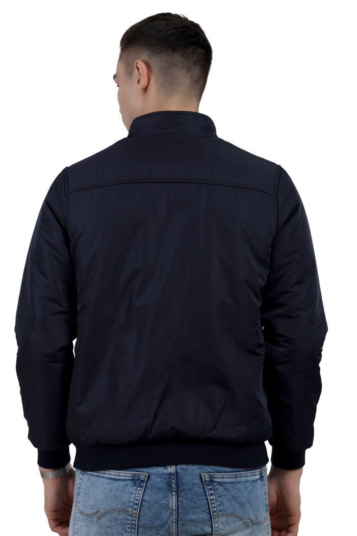 A back pose of a man wearing a Navy-Red Reversible jacket with a high neck collar, zipper closure, and pocket in hand designed for casual winter layering and comfort.