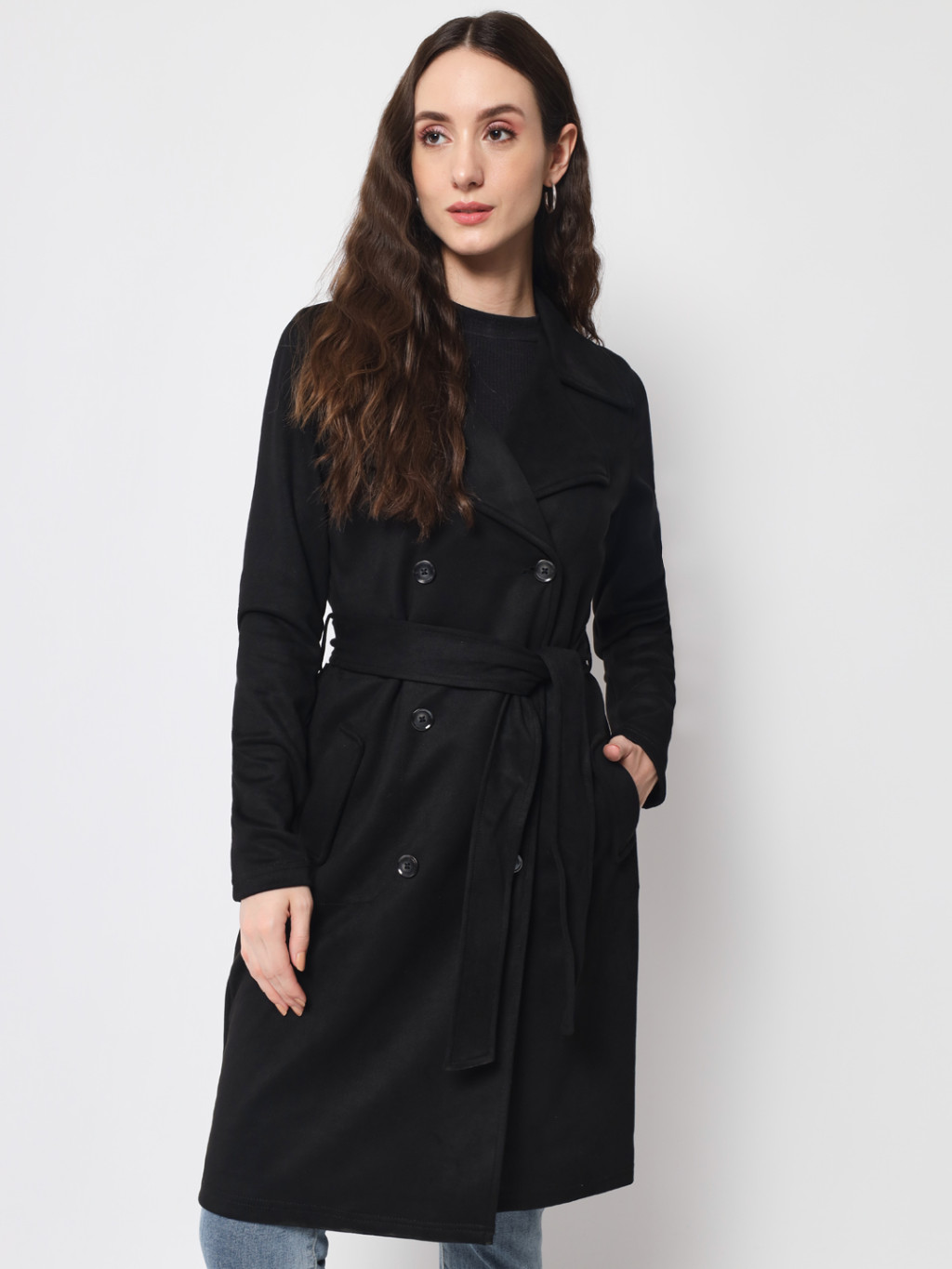 A woman wearing a Black Long Coat with a lapel collar and matching belt designed for formal and casual winter layering and comfort