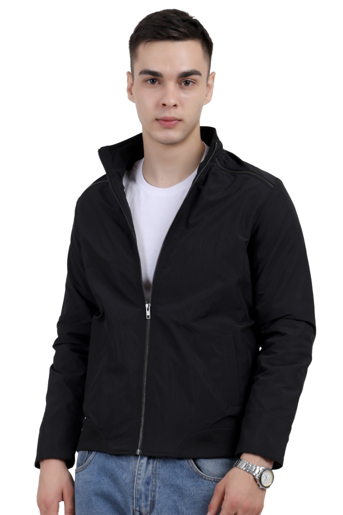 A man wearing a Black Riding jacket with a high collar neck, zipper closure and pocket in hand designed for casual winter layering and comfort.