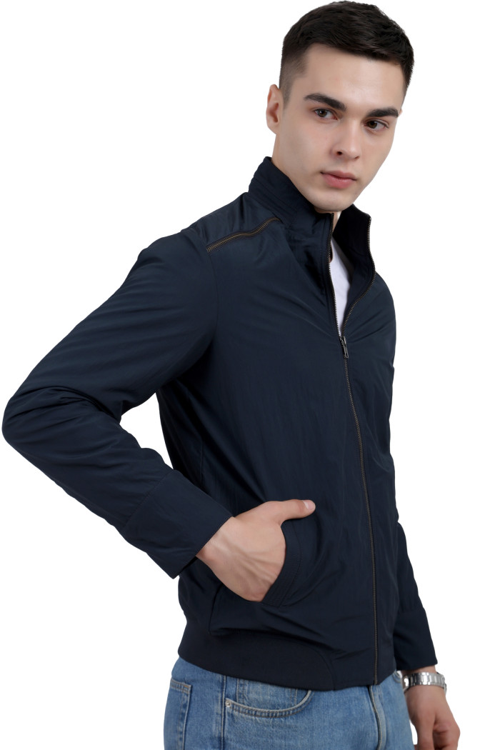 A left pose of a man wearing a Navy Riding jacket with a high, zipper closure and pocket in hand designed for casual winter layering and comfort.