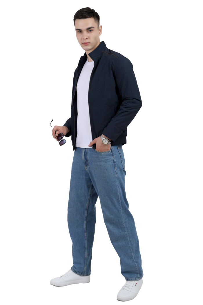 A tilted pose of a man wearing a Navy riding jacket with a high neck, zipper closure and pocket in hand designed for casual winter layering and comfort.