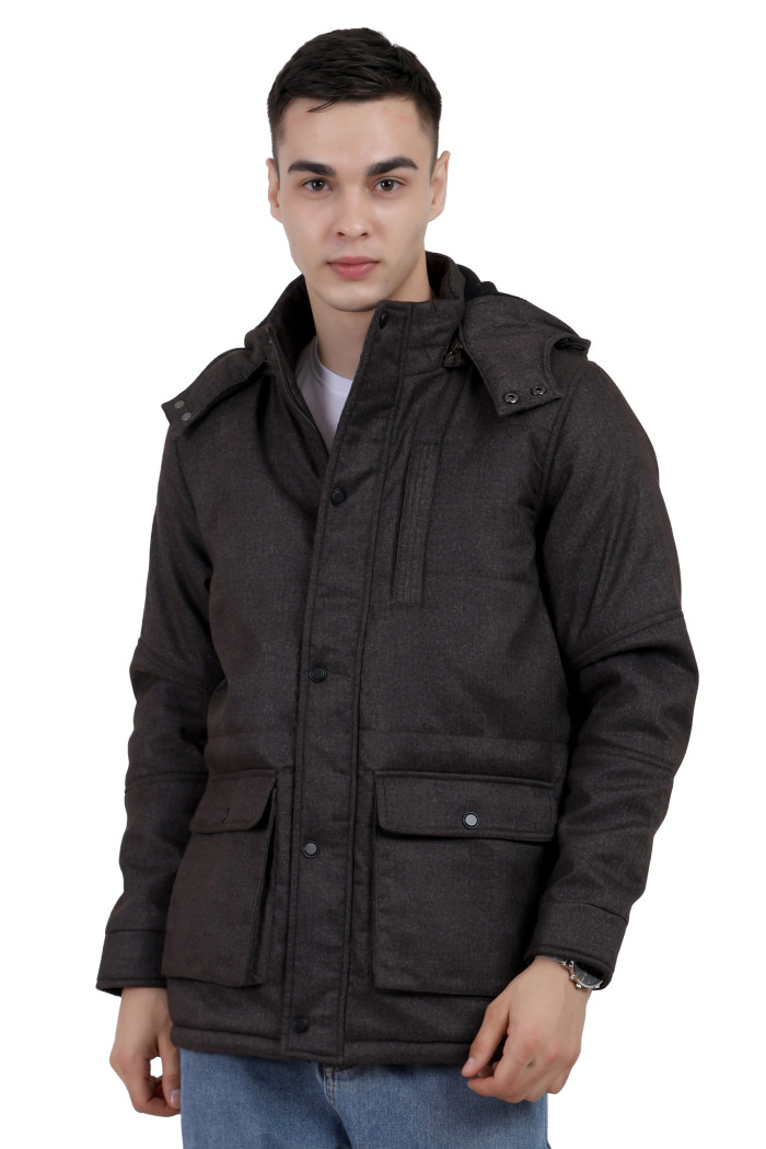 A man wearing a brown Chester jacket with a high neck collar, hood, zipper closure and pocket in hand designed for casual winter layering and comfort.