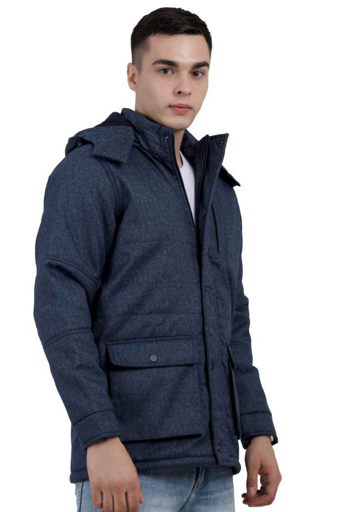 A left pose of a man wearing Navy Chester jacket with a high neck collar, hood , zipper closure and pocket in hand designed for casual winter layering and comfort.