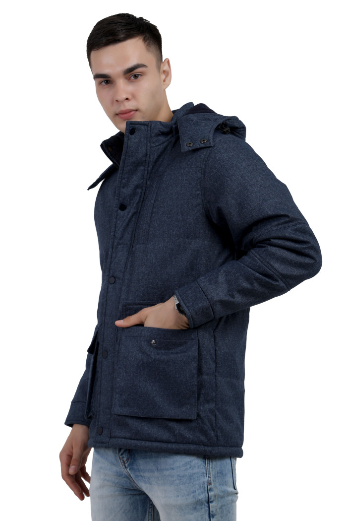 A right pose of a man wearing Navy Chester jacket with a high neck collar, hood, zipper closure and pocket in hand designed for casual winter layering and comfort.