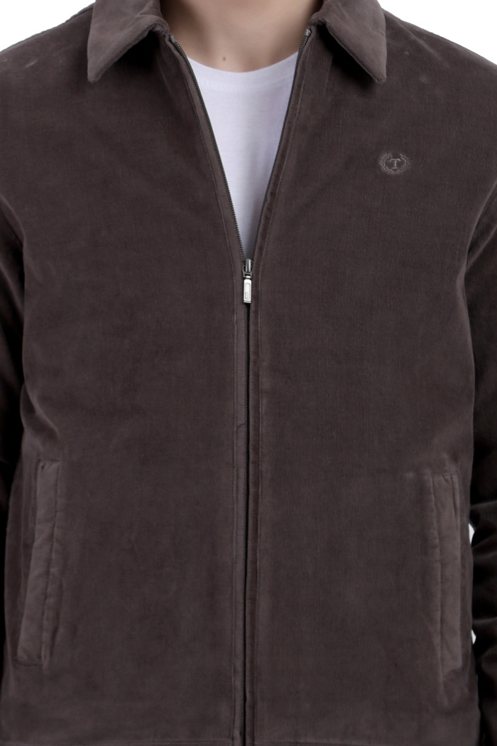 A cropped image of a man wearing a Dark Grey Corduroy jacket with a collar neck, zipper closure and pocket in hand designed for casual winter layering and comfort.