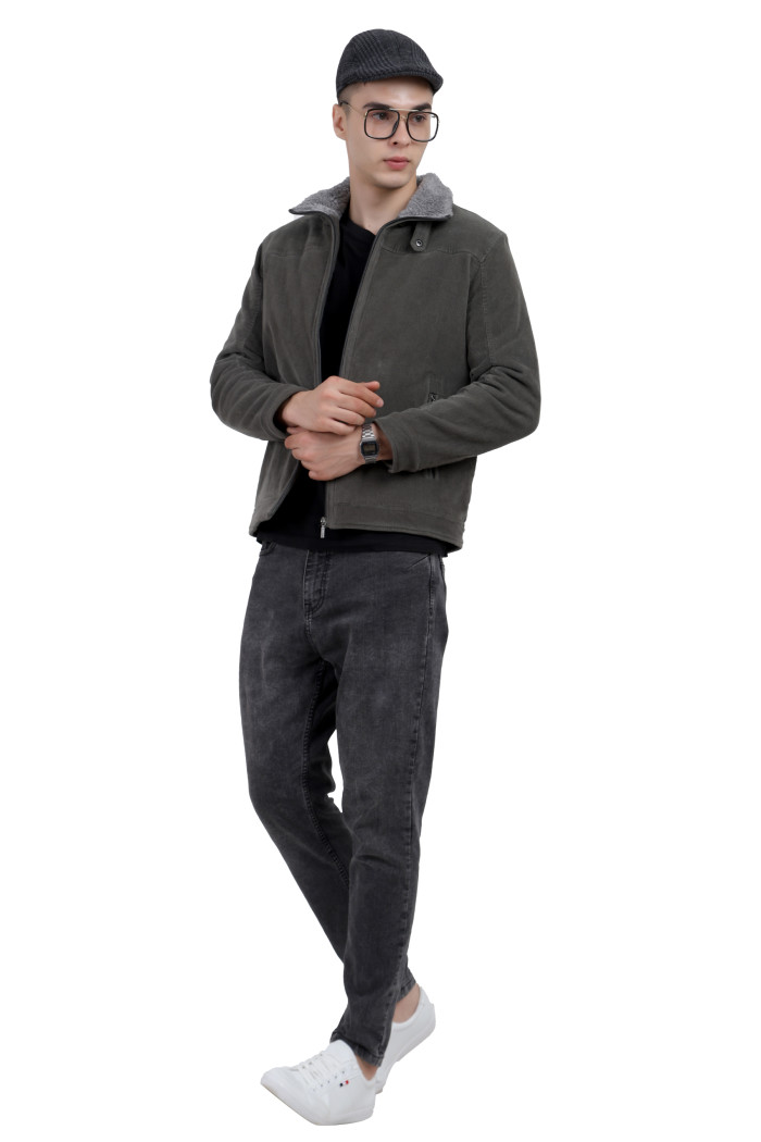 A tilted pose of a man wearing a Pista washed Corduroy jacket with a collar neck, zipper closure and pocket in hand designed for casual winter layering and comfort.