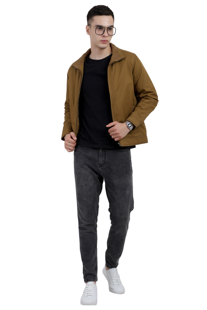 A tilted pose of a man wearing a Khaki cotton jacket with a collar neck, zipper closure and pocket in hand designed for casual winter layering and comfort.