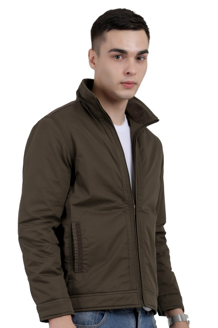 A left pose of a man wearing an Olive cotton jacket with a collar neck, zipper closure and pocket in hand designed for casual winter layering and comfort.