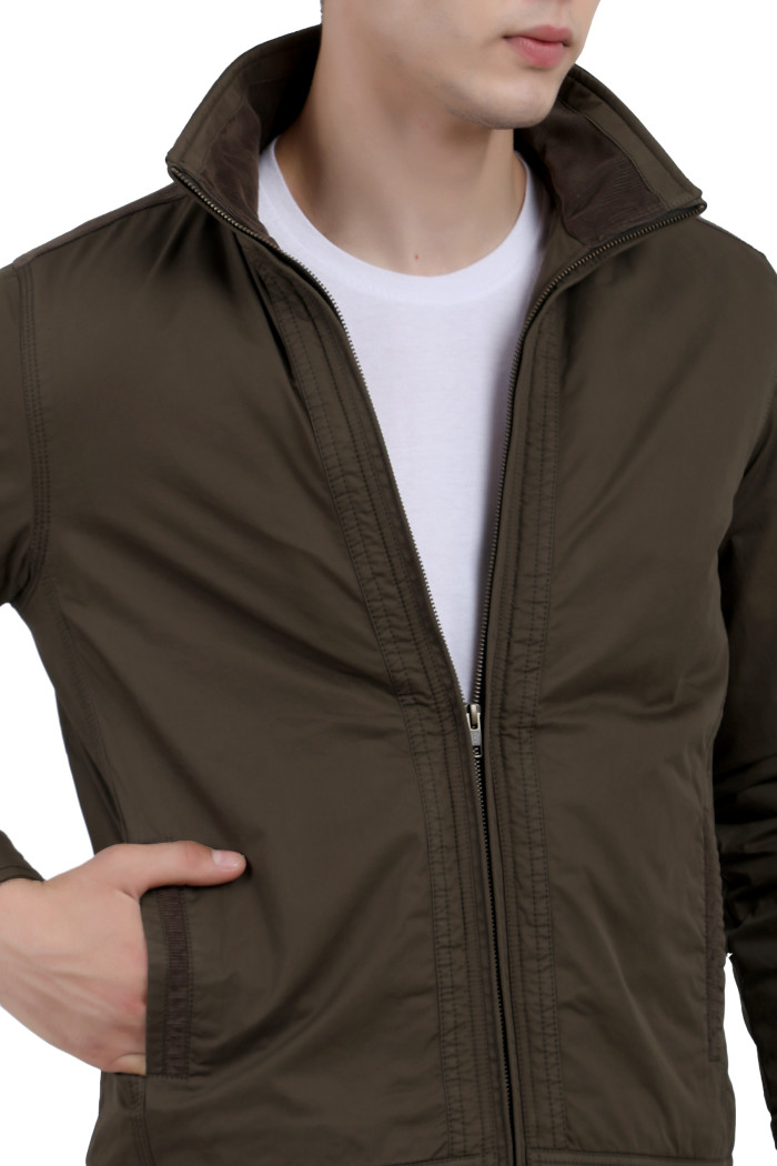 A cropped image of a man wearing an Olive cotton jacket with a collar neck, zipper closure and pocket in hand designed for casual winter layering and comfort.