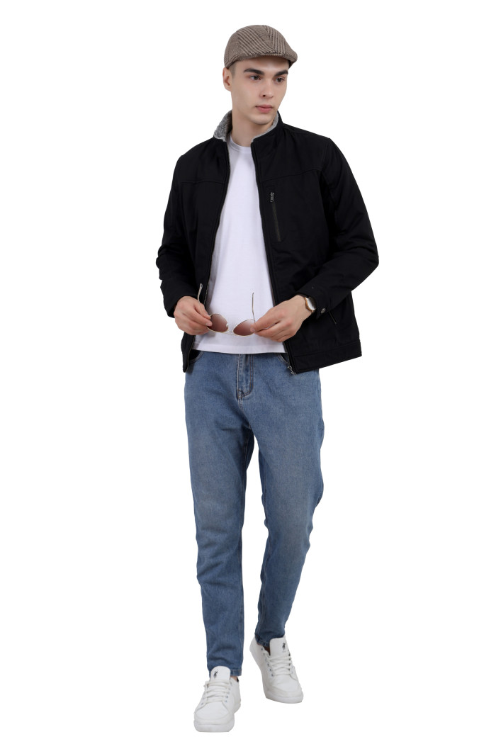 A tilted pose of a man wearing a Black cotton jacket with a collar neck, zipper closure and pocket in hand designed for casual winter layering and comfort.