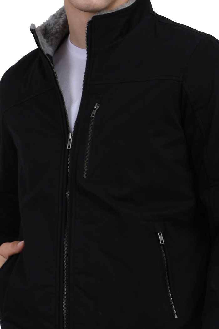 A cropped image of a man wearing Black cotton jacket with a collar neck, zipper closure and pocket in hand designed for casual winter layering and comfort.