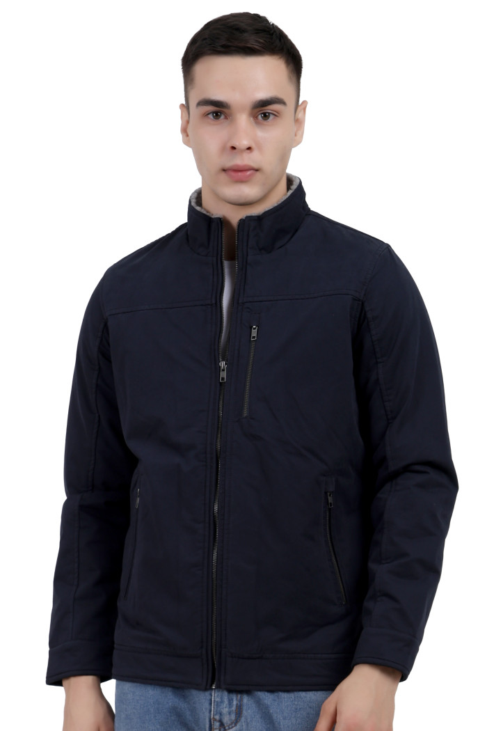 A man wearing a Navy cotton jacket with a collar neck, zipper closure and pocket in hand designed for casual winter layering and comfor