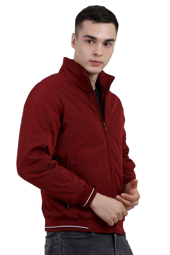 A left pose of a man wearing a Maroon polyester jacket with a collar neck, zipper closure and pocket in hand designed for casual winter layering and comfort.