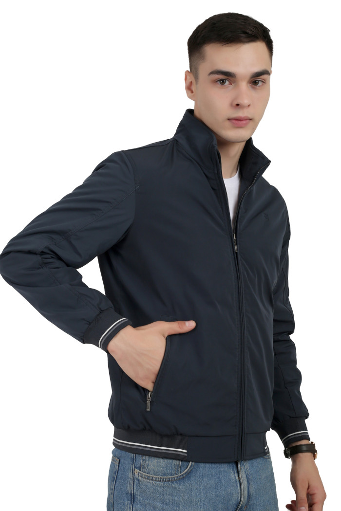 A left pose of a man wearing a Navy polyester jacket with a collar neck, zipper closure and pocket in hand designed for casual winter layering and comfort.