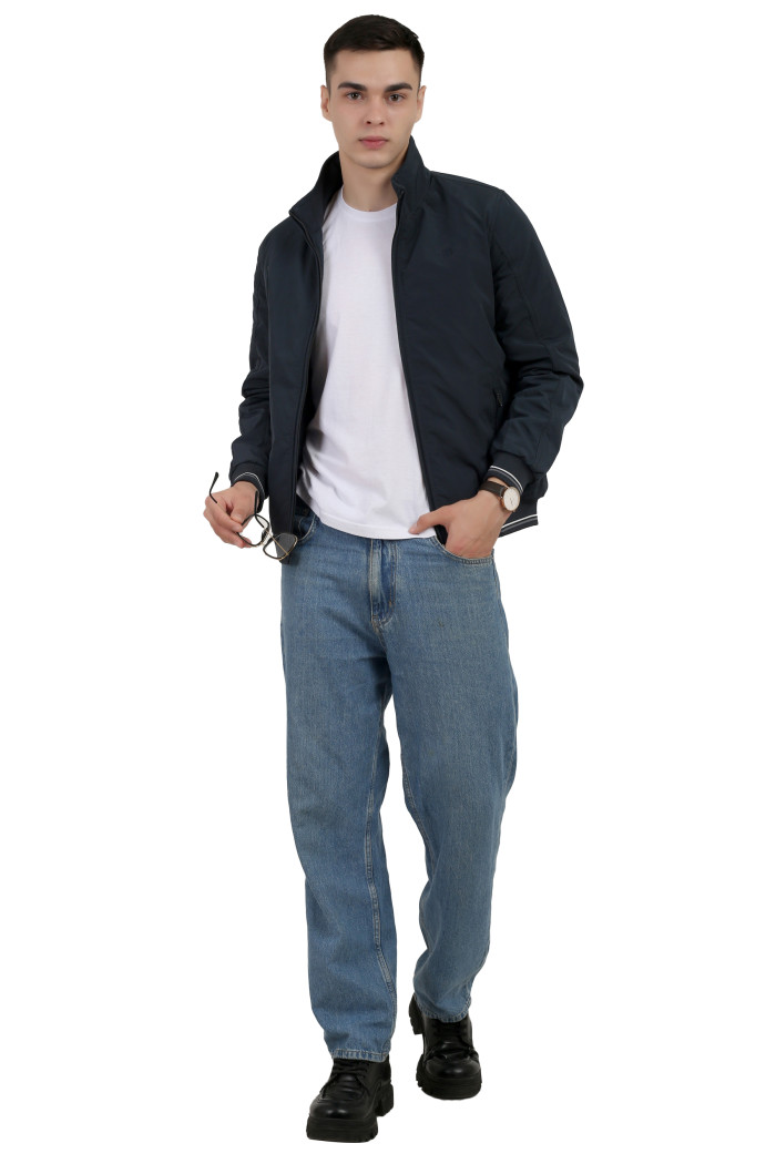 A tilted pose of a man wearing a Navy polyester jacketwith a collar neck, zipper closure and pocket in hand designed for casual winter layering and comfort.