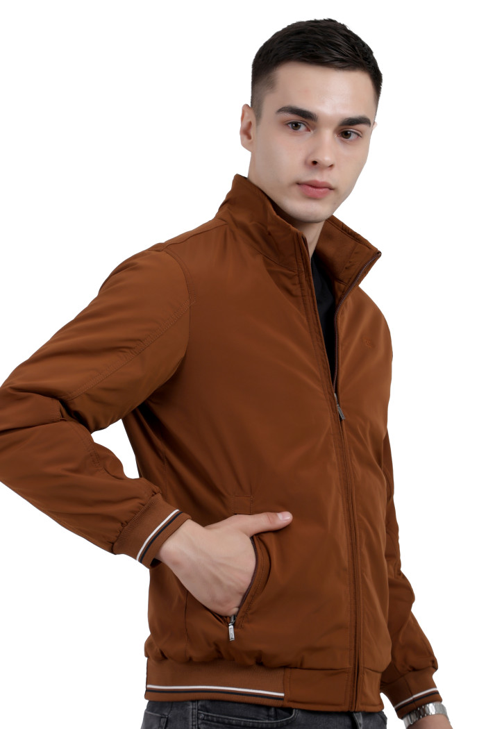 A man wearing a Rust polyester jacket with a collar neck, zipper closure and pocket in hand designed for casual winter layering and comfort.