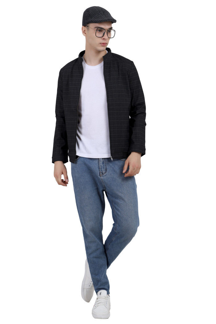 A tilted pose of a man wearing a Black cotton washed winter jacket with fleece lining,mock collar, zipper closure, and pocket in hand designed for casual winter layering and comfort.