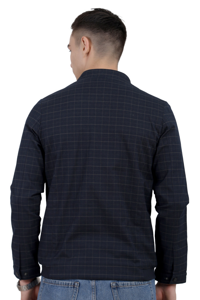 A back pose of a man wearing a navy cotton washed winter jacket with fleece lining,mock collar, zipper closure, and pocket in hand designed for casual winter layering and comfort.