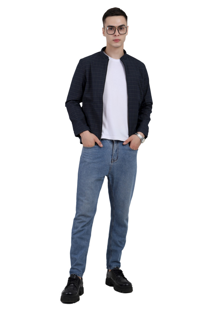 A tilted pose of a man wearing a navy cotton washed winter jacket with fleece lining,mock collar, zipper closure, and pocket in hand designed for casual winter layering and comfort.