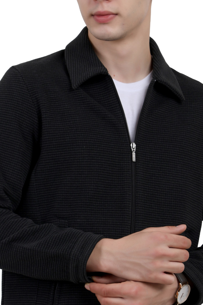 A cropped image of a man wearing a Black Tweed Shacket with a collar neck, zipper closure and pocket in hand designed for casual winter layering and comfort.