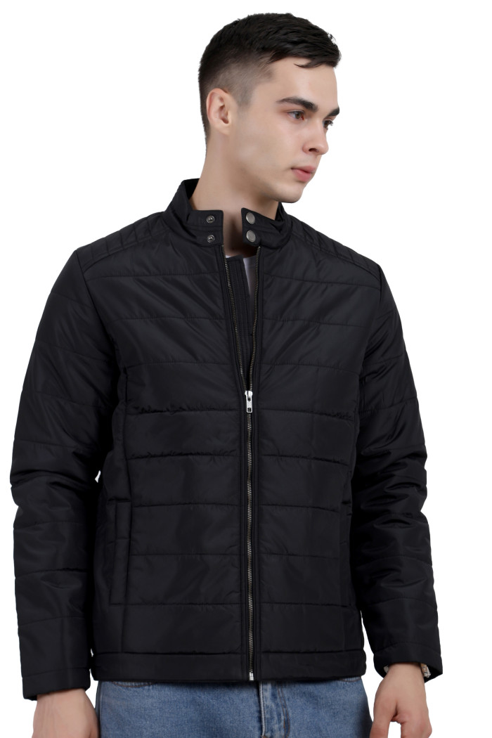 A man wearing a black quilted biker Jacket with mock collar, zipper closure, and pocket in hand designed for casual winter layering and comfort.