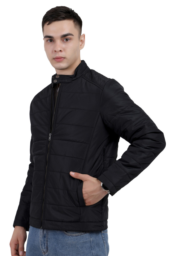 A left pose of a man wearing a black quilted biker Jacket with mock collar, zipper closure and pocket in hand designed for casual winter layering and comfort.