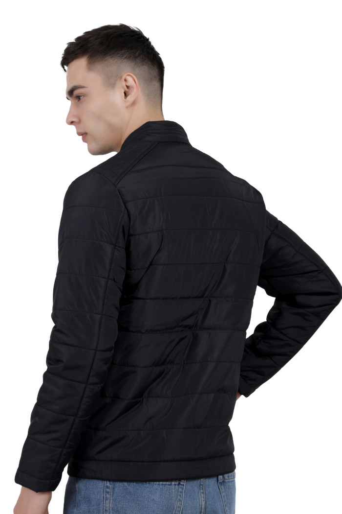 A back pose of a man wearing a black quilted biker Jacket with mock collar, zipper closure and pocket in hand designed for casual winter layering and comfort.