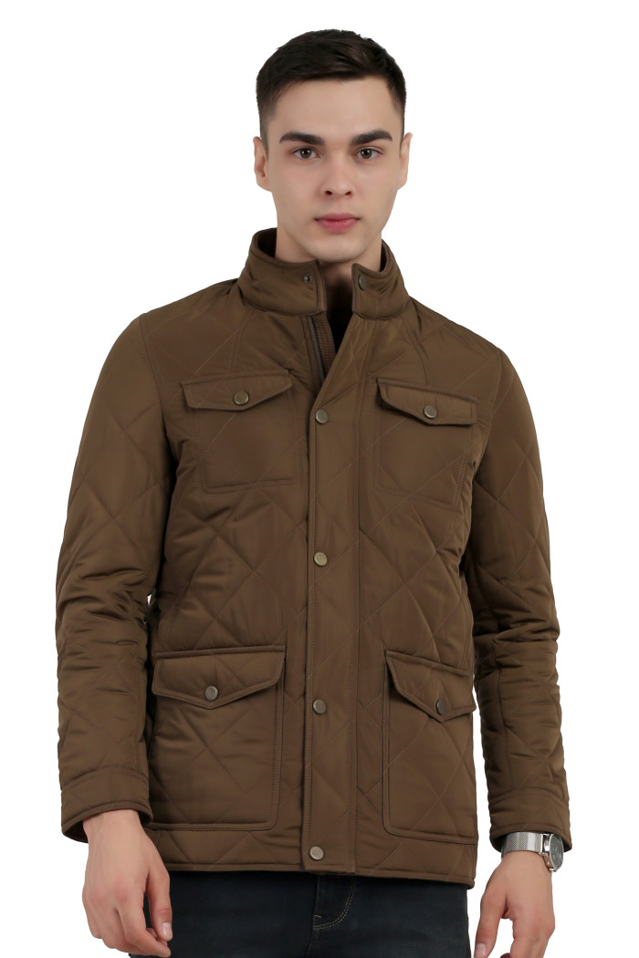 A man wearing a Bronze quilted jacket with a collar neck, zipper closure and pocket in hand designed for casual winter layering and comfort.