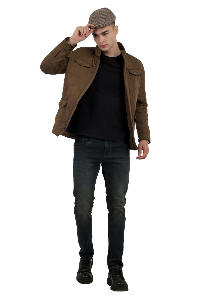 A tilted pose of a man wearing a Bronze quilted jacket t with a collar neck, zipper closure and pocket in hand designed for casual winter layering and comfort.