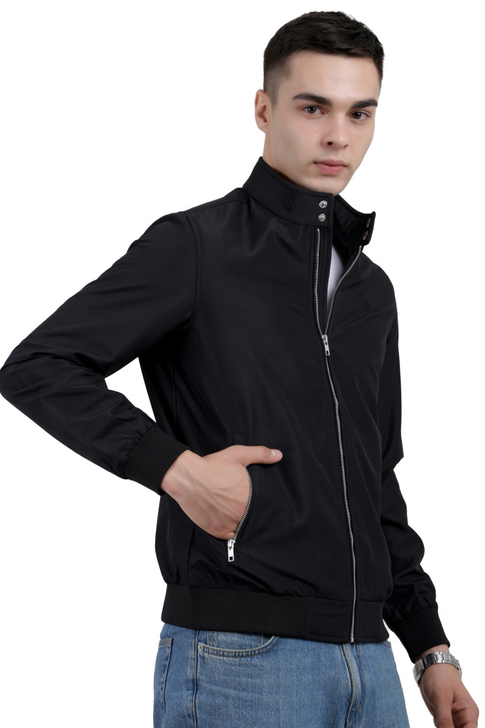 A right pose of a man wearing a Black Matt Finish Lightweight Jacket with high neck collar, zipper closure and pocket in hand designed for casual winter layering and comfort.