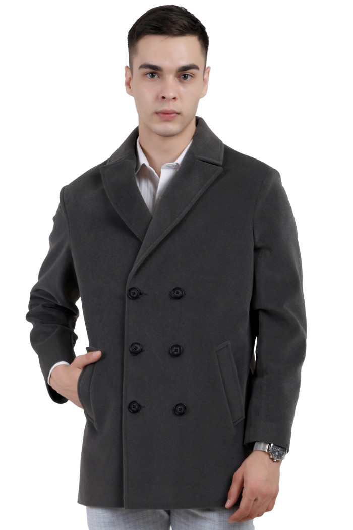 A man wearing a Charcoal Double double-breasted knee Length Velvet Coat with a Lapel collar neck, Button closure and pocket in hand designed for casual winter layering and comfort.