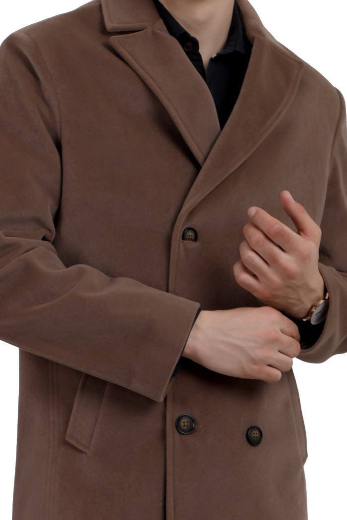 A cropped image of a man wearing a Mouse Double Breasted Knee Length Velvet Coat with a Lapel collar neck, Button closure and pocket in hand designed for casual winter layering and comfort.