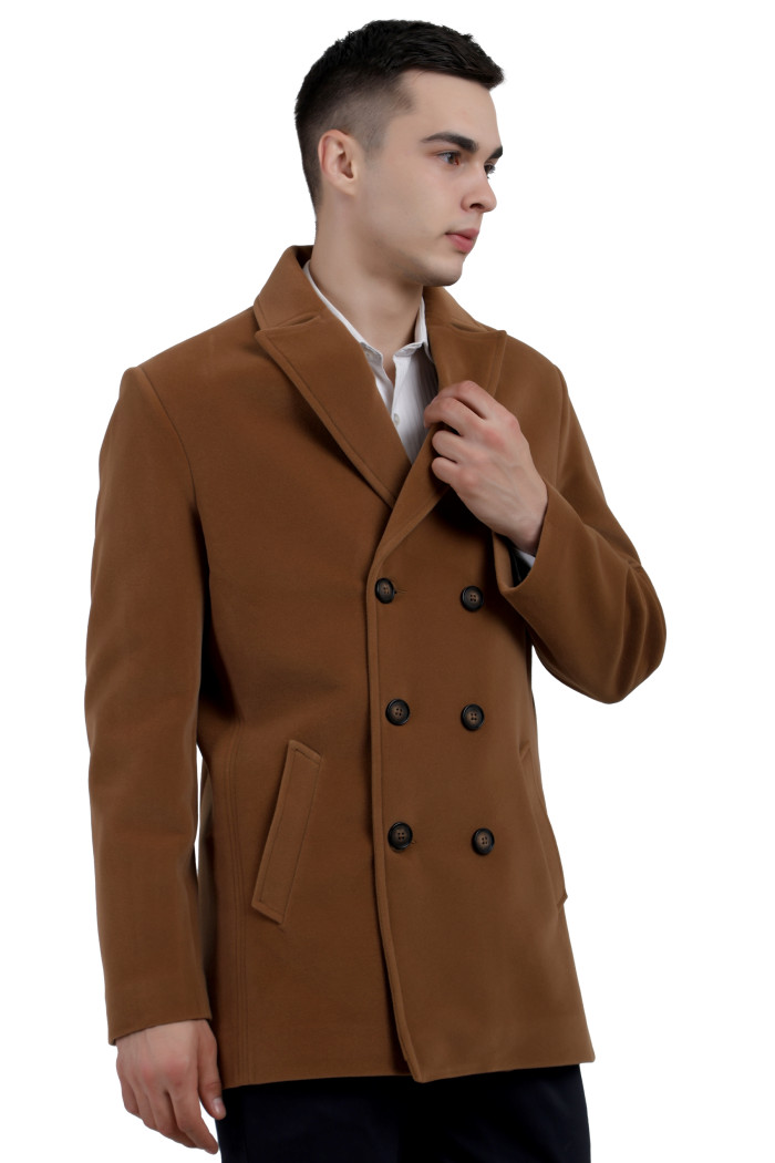 A left pose of a man wearing a tan double-breasted Length Velvet Coat with a Lapel collar neck, Button closure and pocket in hand designed for casual winter layering and comfort.