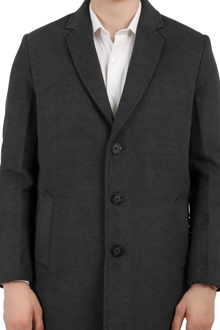 A cropped image of a man wearing an Anthra Single Breasted Tweed Long Coat with a Lapel collar neck, Button closure and pocket in hand designed for casual winter layering and comfort.