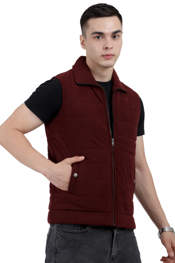 A left pose of a man wearing a Maroon half jacket with a high neck, zipper closure and pocket in hand designed for casual winter layering and comfort.