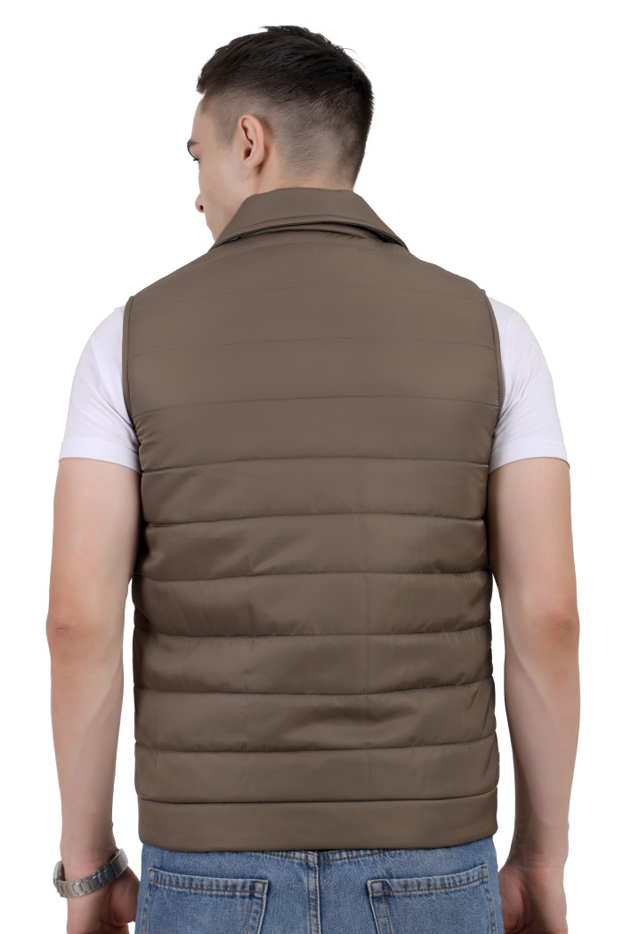 A back pose of a man wearing a Mouse half jacket with a high neck ,zipper closure and pocket designed for casual winter layering and comfort.